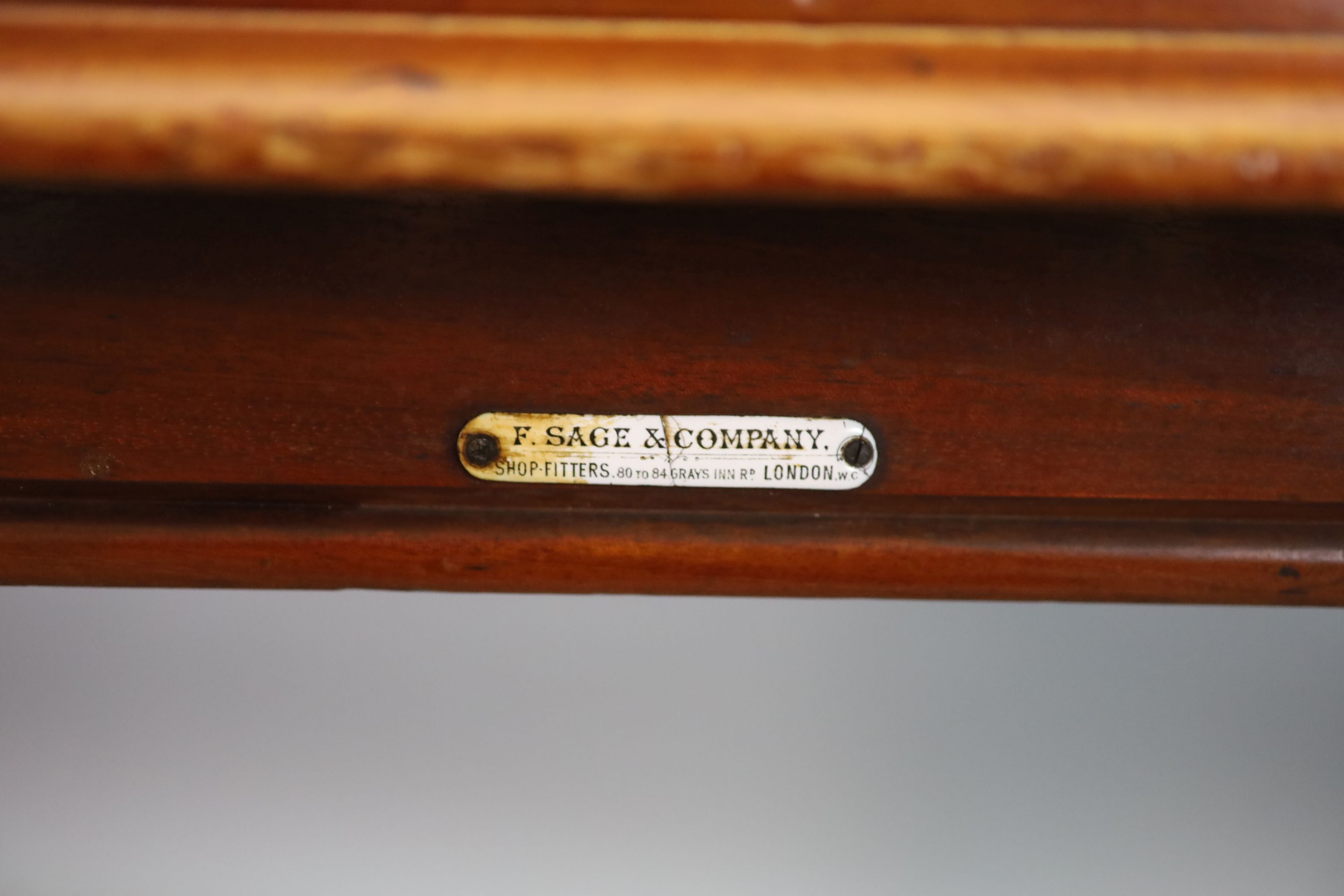 A Victorian mahogany writing table, supplied by Sage & Co. Shopfitters of London, W.112cm D.68cm H.79cm